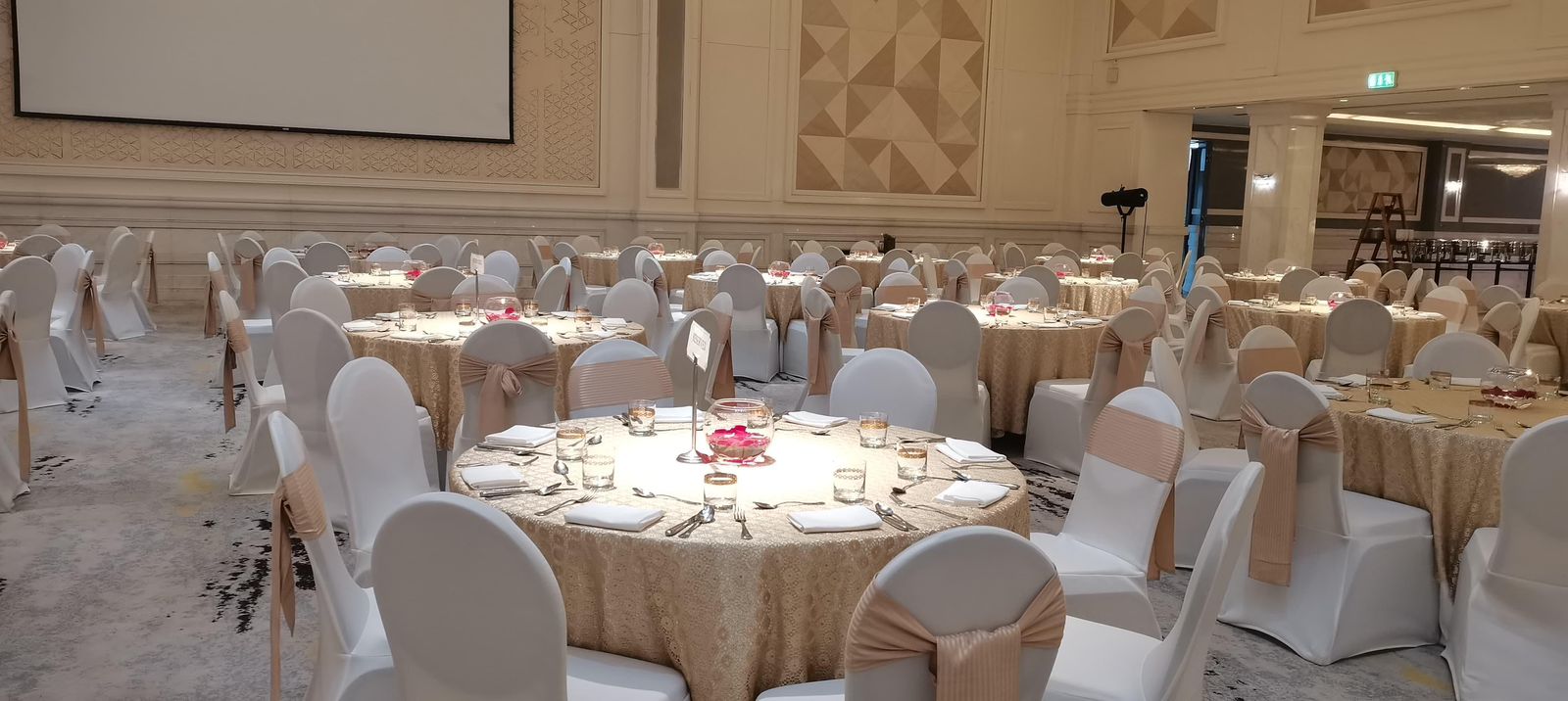 Round ballroom dining tables arranged for a formal event