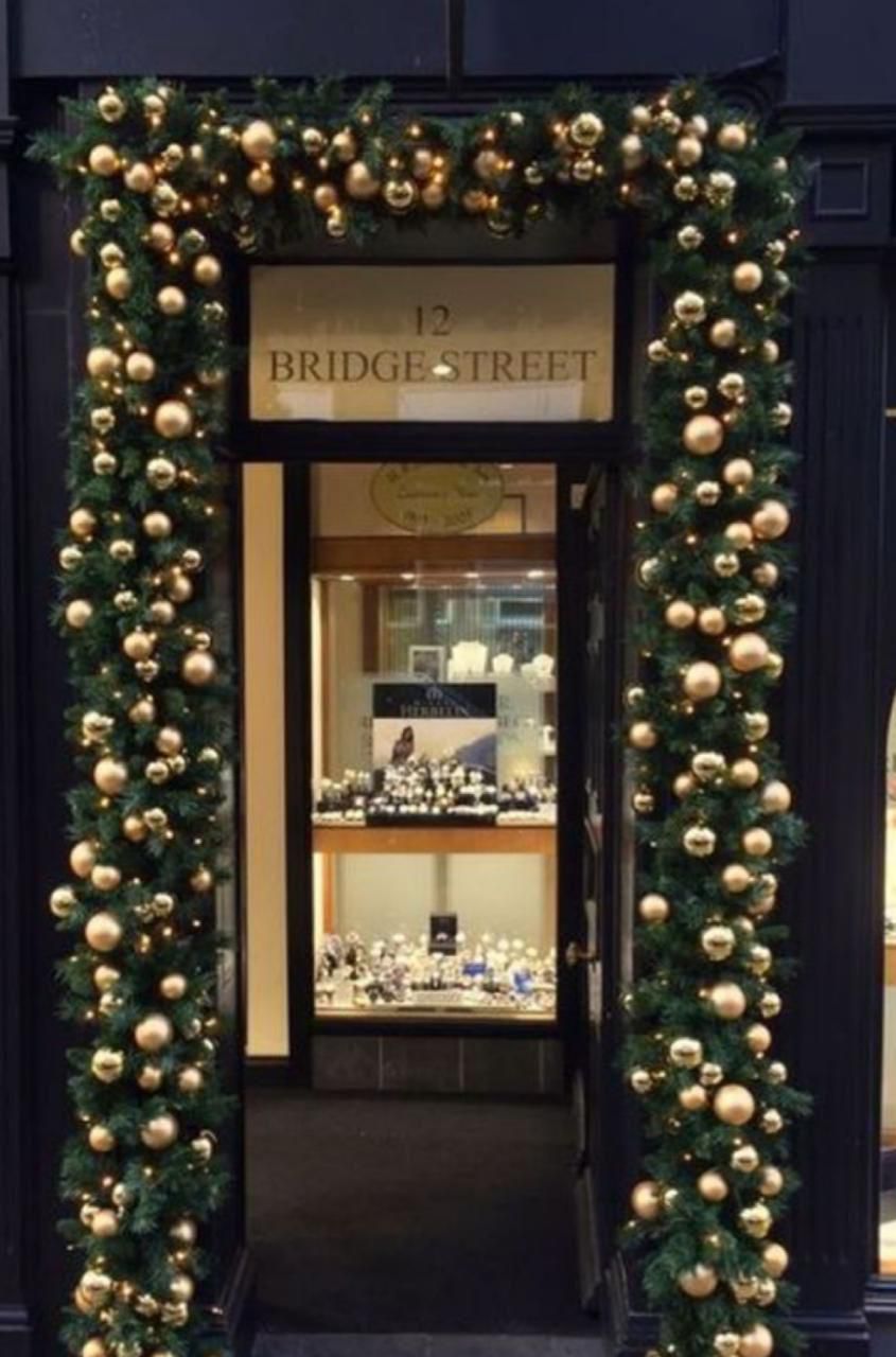 Holiday doorway decorated with Christmas ornament columns