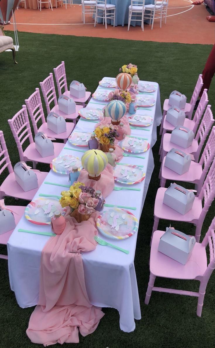 Pastel pink kids tablescape with matching seating and decor